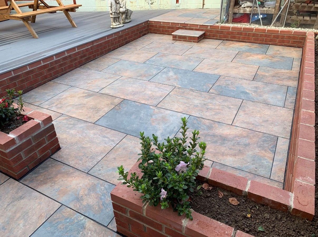Sandstone patio with brick borders built by P.A. Vine & Son